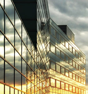 Sun setting over glass building